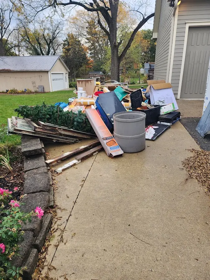 Dumpster being loaded with debris for 10 Yard Dumpster Rental in West Brunswick